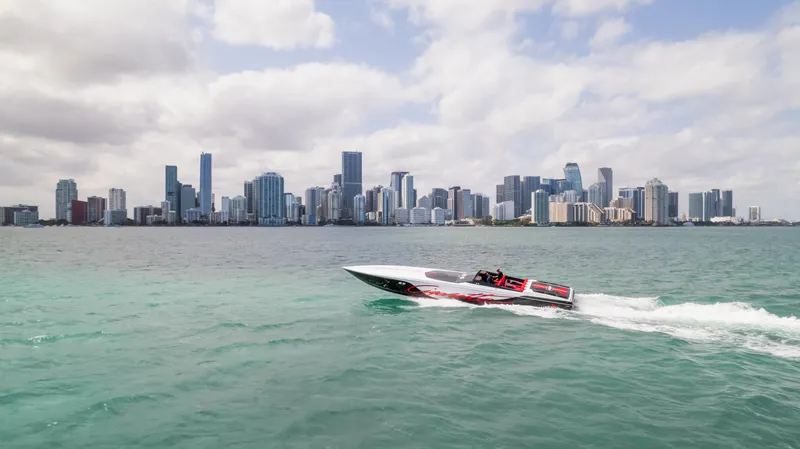 Slide: The Image of Cigarette 515 speedboat cruising near city skyline, 2022 model. - 2