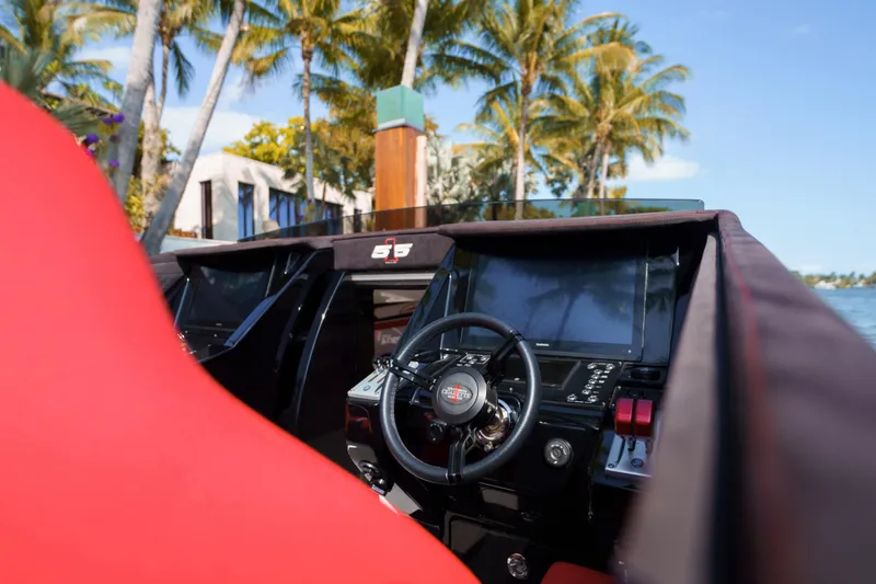 Slide: The Image of Cigarette 515 boat cockpit with red seats, palm trees in background, 2022 model. - 6