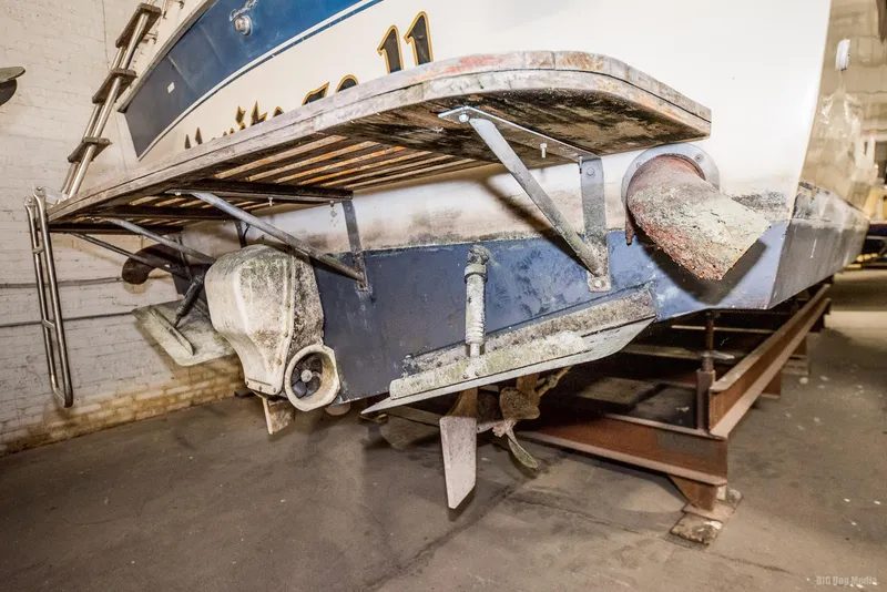 Slide: The Image of 1985 Chris-Craft 336 Mid Cabin boat in storage, showing stern and propeller details. - 11