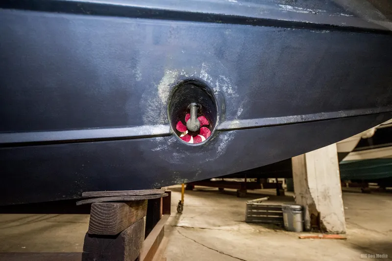 Slide: The Image of 1985 Chris-Craft 336 Mid Cabin boat hull in storage, showing propeller detail. - 15