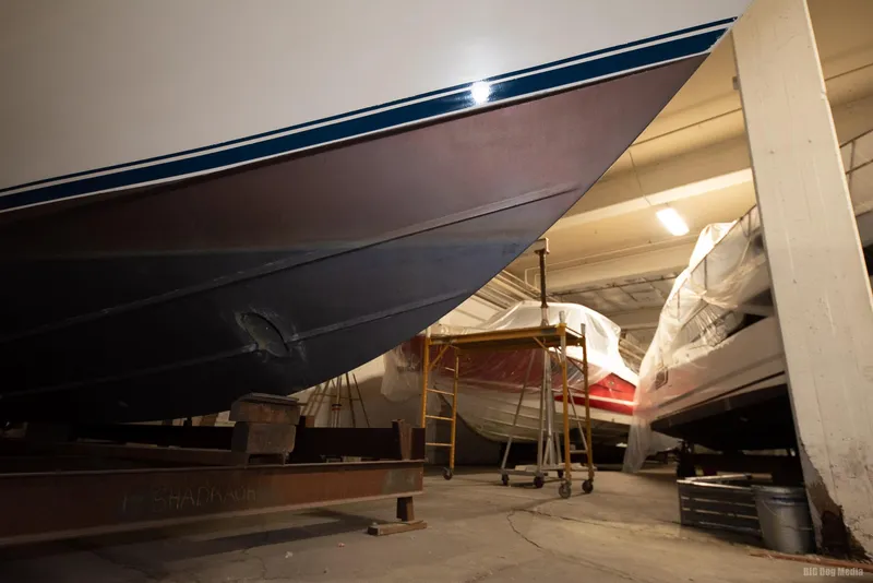 Slide: The Image of 1985 Chris-Craft 336 Mid Cabin boat in indoor storage facility. - 16