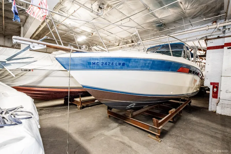Slide: The Image of 1985 Chris-Craft 336 Mid Cabin boat in indoor storage facility. - 21