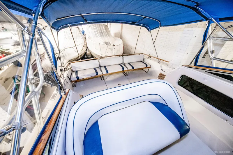 Slide: The Image of 1985 Chris-Craft 336 Mid Cabin boat interior with blue and white seating and canopy. - 25