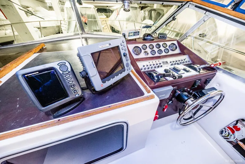 Slide: The Image of 1985 Chris-Craft 336 Mid Cabin helm with navigation equipment and controls. - 28