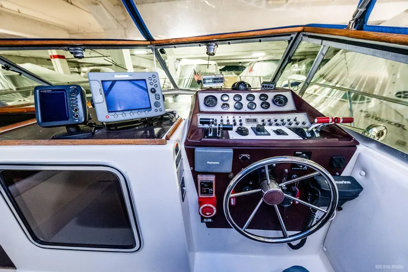 Slide: The Image of 1985 Chris-Craft 336 Mid Cabin boat cockpit with navigation equipment and steering wheel. - 30