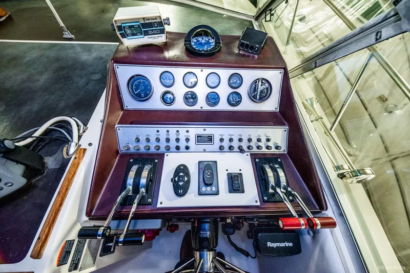 Slide: The Image of 1985 Chris-Craft 336 Mid Cabin boat dashboard with gauges and controls. - 32