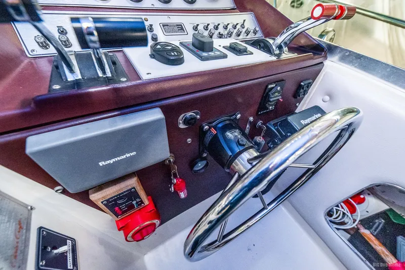Slide: The Image of Control panel of 1985 Chris-Craft 336 Mid Cabin boat with steering wheel and instruments. - 33