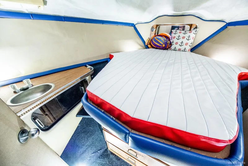 Slide: The Image of 1985 Chris-Craft 336 Mid Cabin interior with bed and kitchenette. - 36
