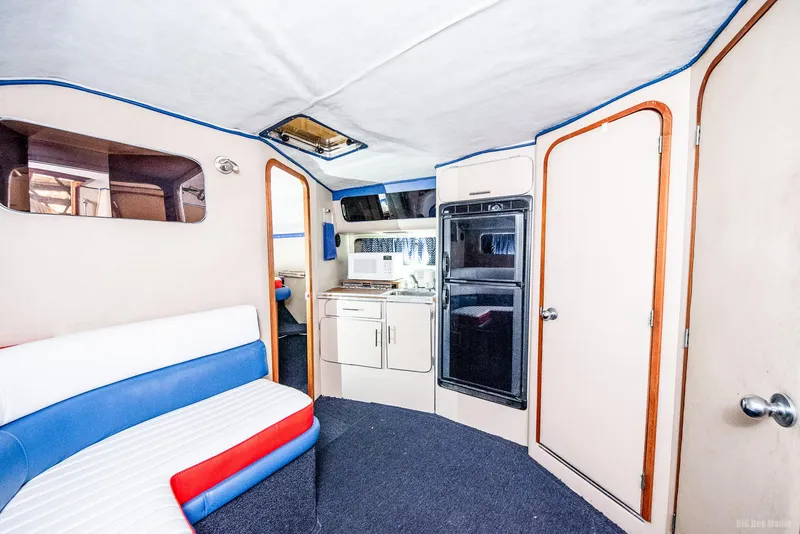 Slide: The Image of 1985 Chris-Craft 336 Mid Cabin interior with kitchenette and seating area. - 46