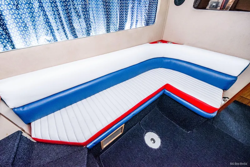Slide: The Image of 1985 Chris-Craft 336 Mid Cabin interior with red, white, and blue seating. - 47