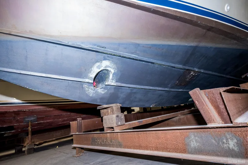Slide: The Image of 1985 Chris-Craft 336 Mid Cabin boat hull on a metal trailer. - 7