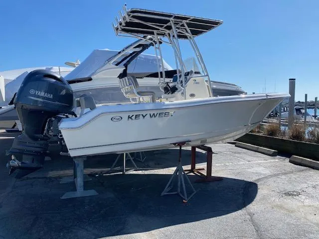 Slide: The Image of 2023 Key West 189 FS boat with Yamaha engine on display at a marina. - 0