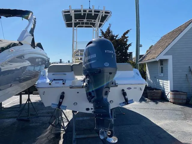 Slide: The Image of 2023 Key West 189 FS boat with Yamaha 150 engine, parked outdoors. - 9