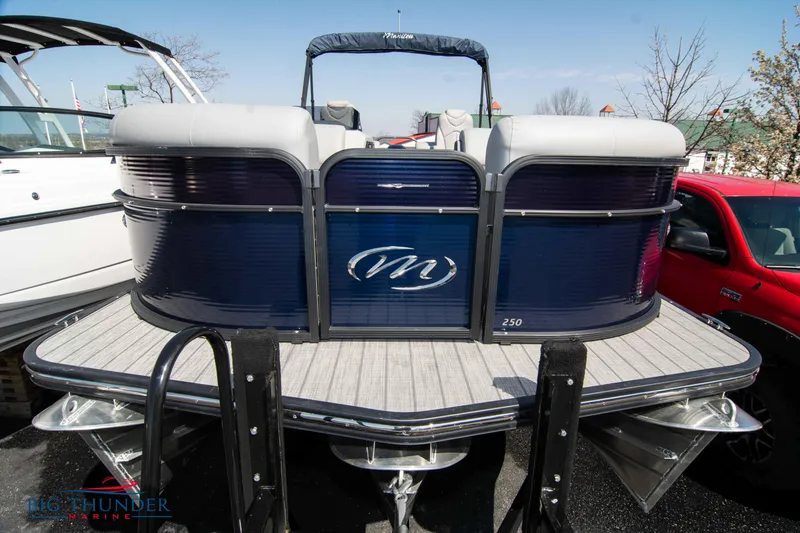 Slide: The Image of 2022 Manitou 25 OASIS RF SHP pontoon boat, blue exterior, docked outdoors. - 1