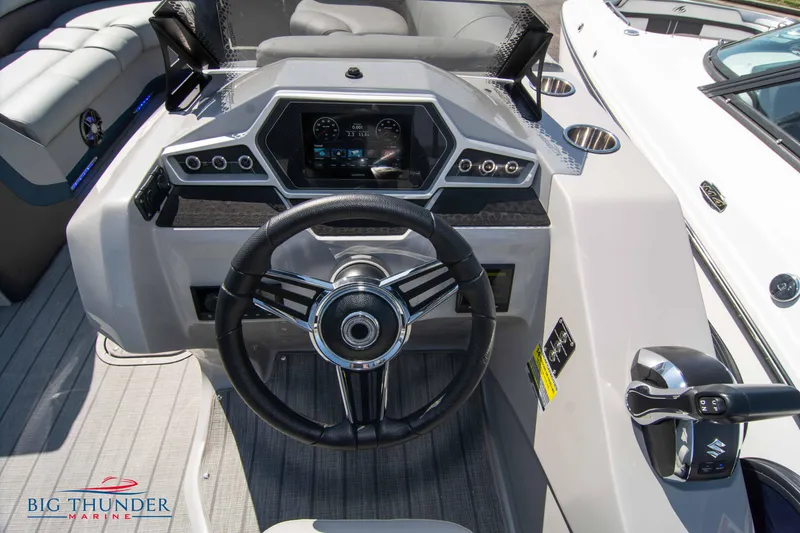 Slide: The Image of 2022 Manitou 25 OASIS RF SHP boat dashboard with steering wheel and controls. - 12
