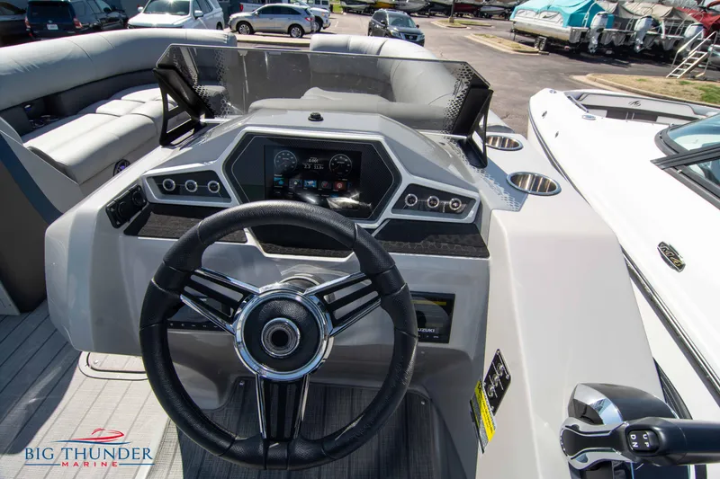 Slide: The Image of 2022 Manitou 25 OASIS RF SHP boat dashboard with steering wheel and controls. - 13