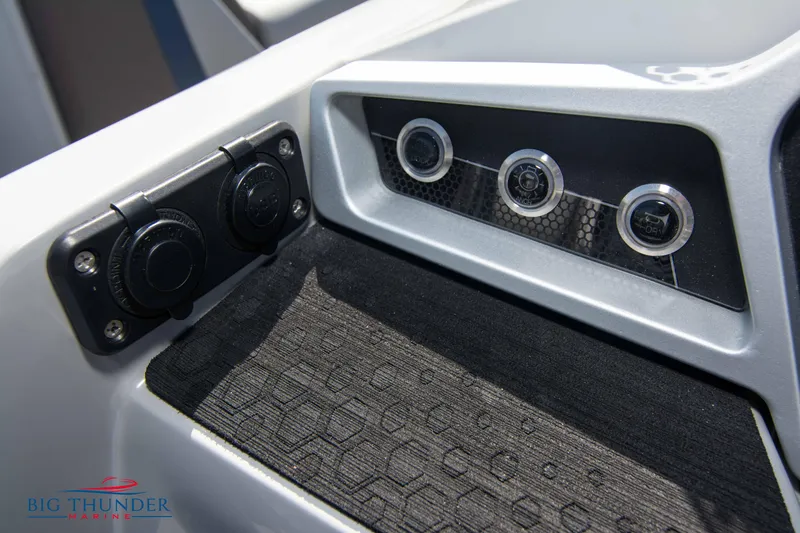 Slide: The Image of Control panel of 2022 Manitou 25 OASIS RF SHP boat with switches and outlets. - 15