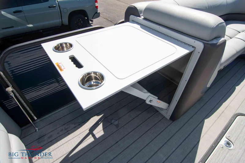 Slide: The Image of 2022 Manitou 25 OASIS RF SHP boat with foldable table and cup holders. - 26