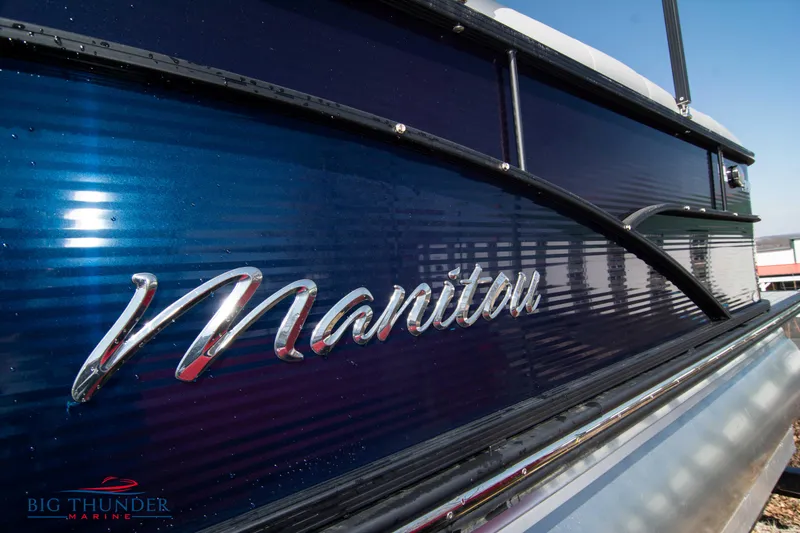 Slide: The Image of 2022 Manitou 25 OASIS RF SHP pontoon boat with sleek blue exterior. - 3
