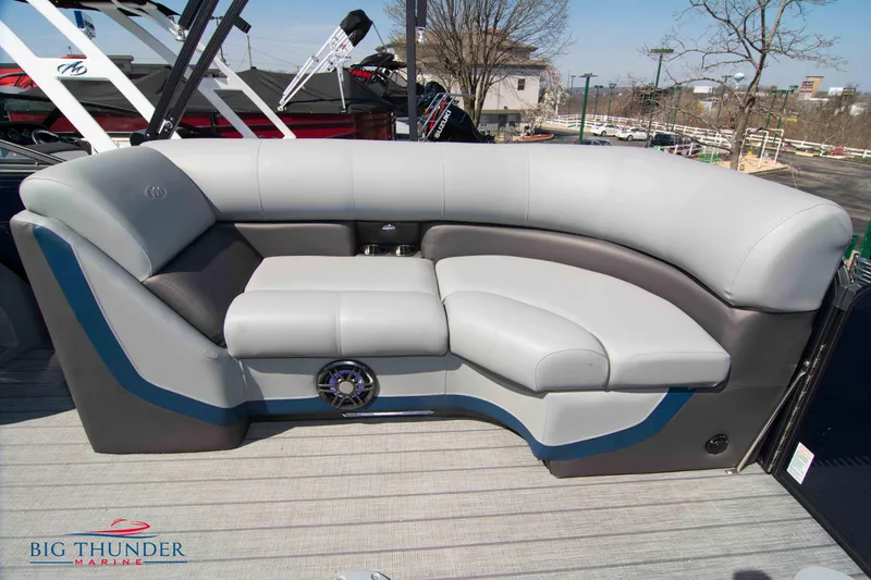 Slide: The Image of 2022 Manitou 25 OASIS RF SHP boat seating with gray upholstery and speaker. - 30