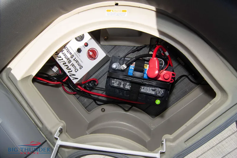 Slide: The Image of 2022 Manitou 25 OASIS RF SHP battery compartment with wiring and smart switch. - 34
