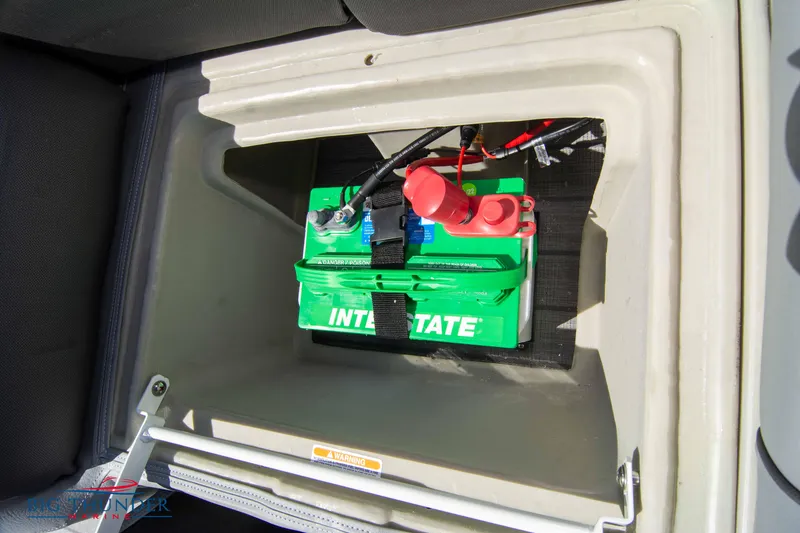 Slide: The Image of 2022 Manitou 25 OASIS RF SHP battery compartment with Interstate battery. - 36