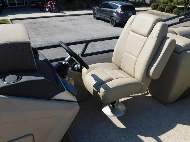 Slide: The Image of 2023 Regency 230 DL3 boat captain's chair and steering console. - 12