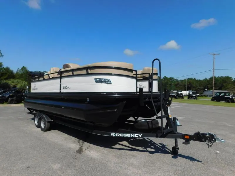 Slide: The Image of 2023 Regency 230 DL3 pontoon boat on a trailer, parked outdoors. - 4