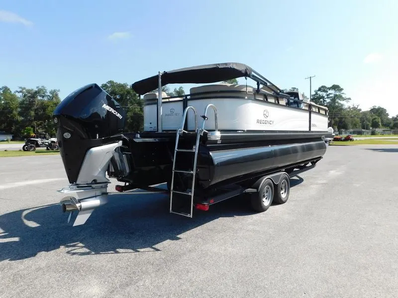 Slide: The Image of 2023 Regency 230 DL3 pontoon boat with Mercury outboard motor on trailer. - 6