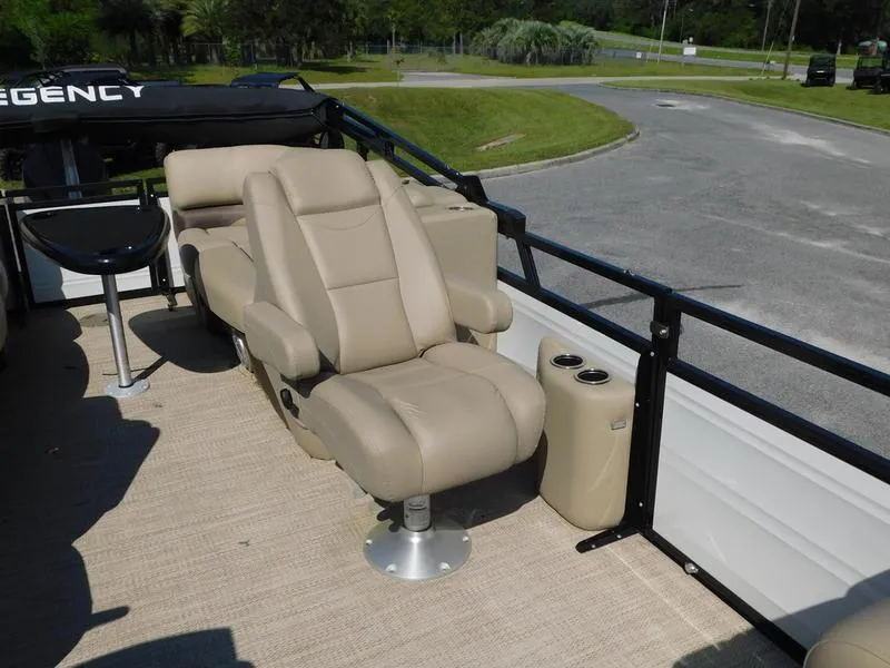Slide: The Image of 2023 Regency 230 DL3 boat interior with beige seating and cup holders. - 9