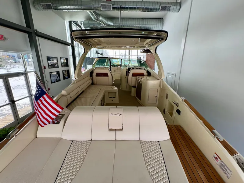 Slide: The Image of 2024 Chris-Craft Launch 35 GT luxury boat interior with elegant seating and American flag. - 34