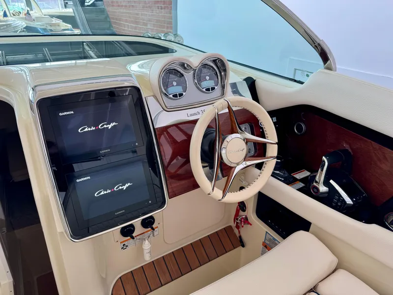 Slide: The Image of 2024 Chris-Craft Launch 35 GT dashboard with dual screens and elegant steering wheel. - 37