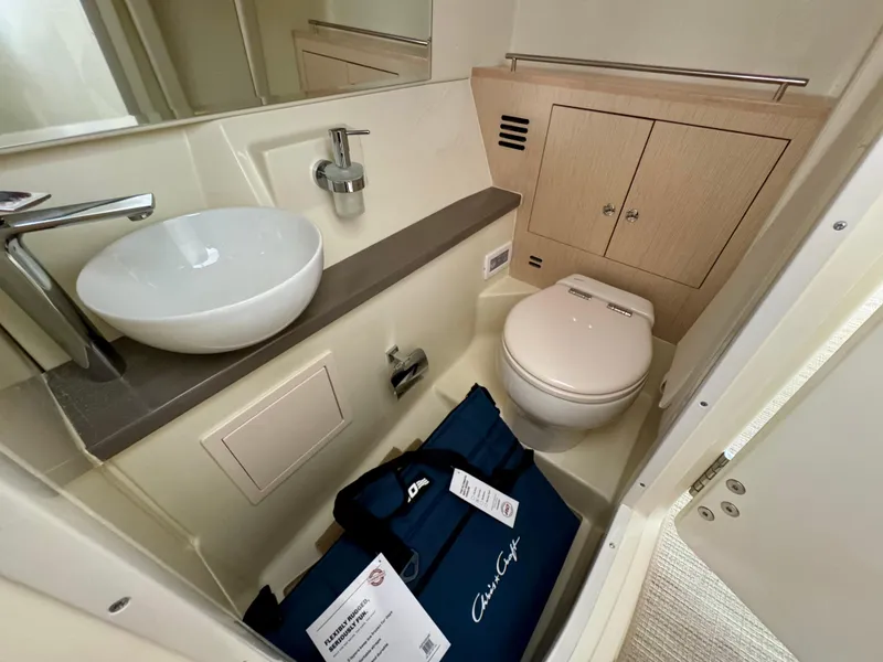Slide: The Image of 2024 Chris-Craft Launch 35 GT bathroom with modern sink, toilet, and storage cabinet. - 41