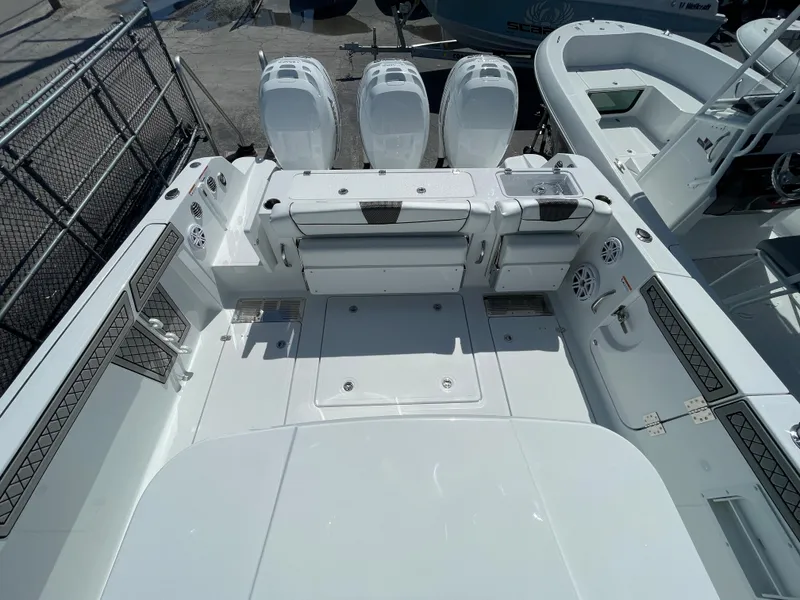 Slide: The Image of 2023 Wellcraft 352 Fisherman boat deck with triple outboard engines. - 10