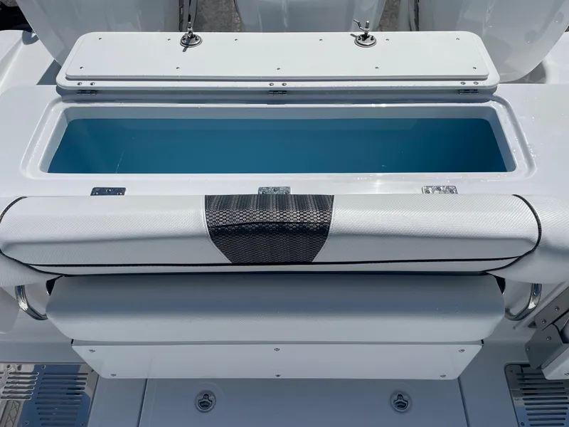 Slide: The Image of 2023 Wellcraft 352 Fisherman boat with open storage compartment and cushioned seating. - 13