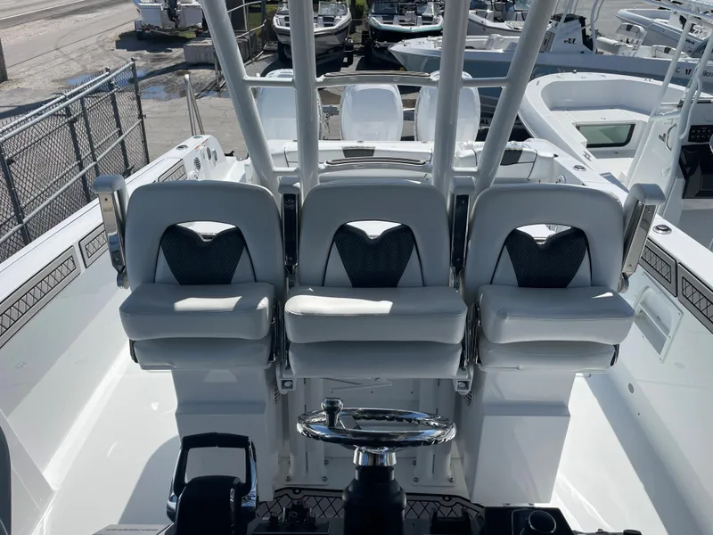 Slide: The Image of 2023 Wellcraft 352 Fisherman boat interior with three cushioned seats and steering wheel. - 15