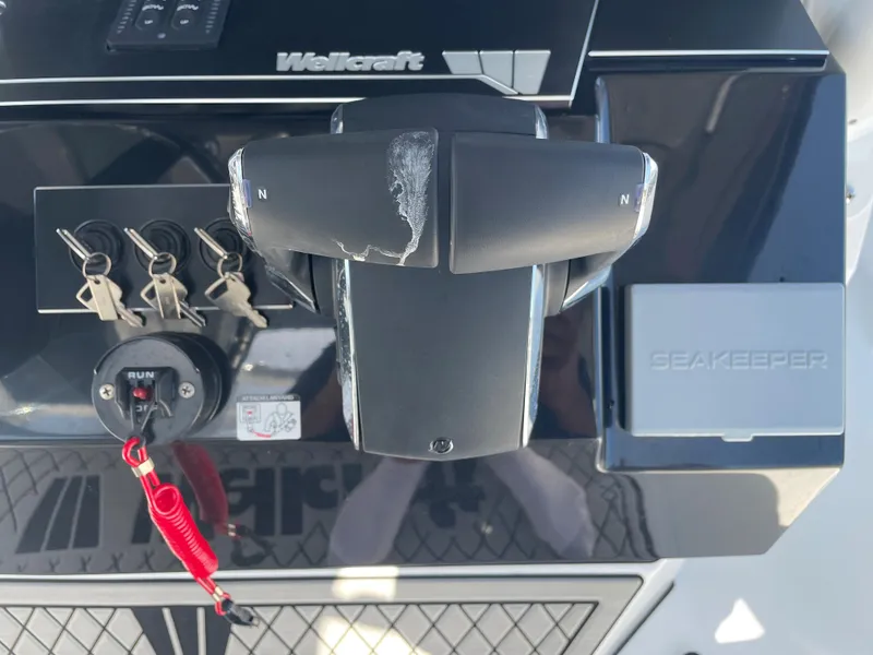 Slide: The Image of Control panel of 2023 Wellcraft 352 Fisherman boat with keys and Seakeeper system. - 18