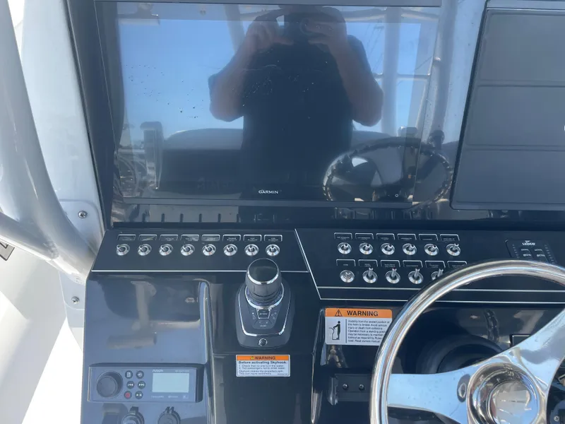 Slide: The Image of 2023 Wellcraft 352 Fisherman dashboard with steering wheel and control panel. - 20