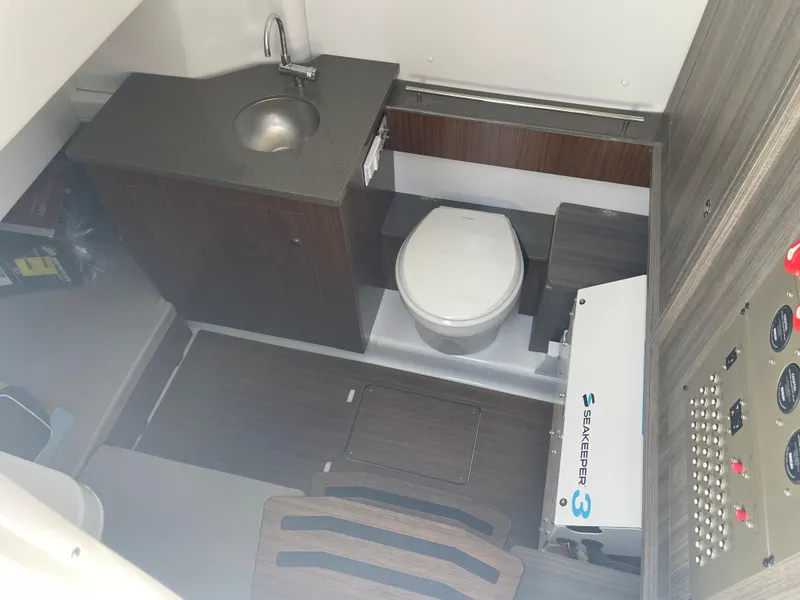 Slide: The Image of 2023 Wellcraft 352 Fisherman boat interior with sink, toilet, and control panel. - 30