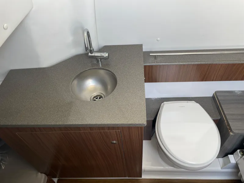 Slide: The Image of 2023 Wellcraft 352 Fisherman boat bathroom with sink and toilet, featuring modern design. - 31