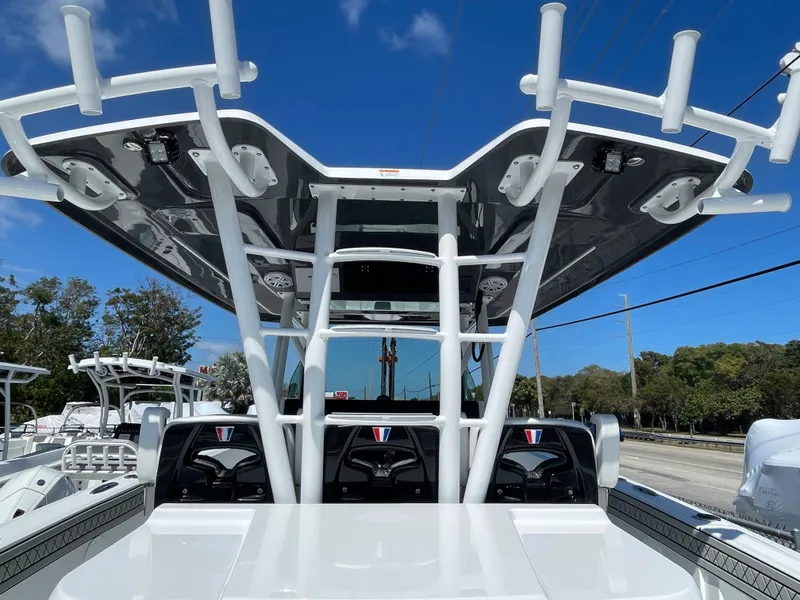 Slide: The Image of 2023 Wellcraft 352 Fisherman boat with T-top under clear blue sky. - 7