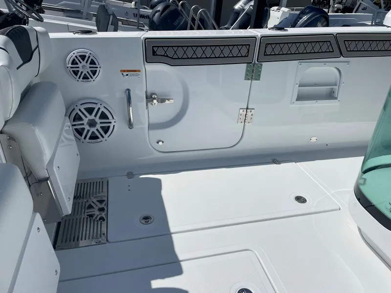 Slide: The Image of 2023 Wellcraft 352 Fisherman boat interior with speakers and seating area. - 8