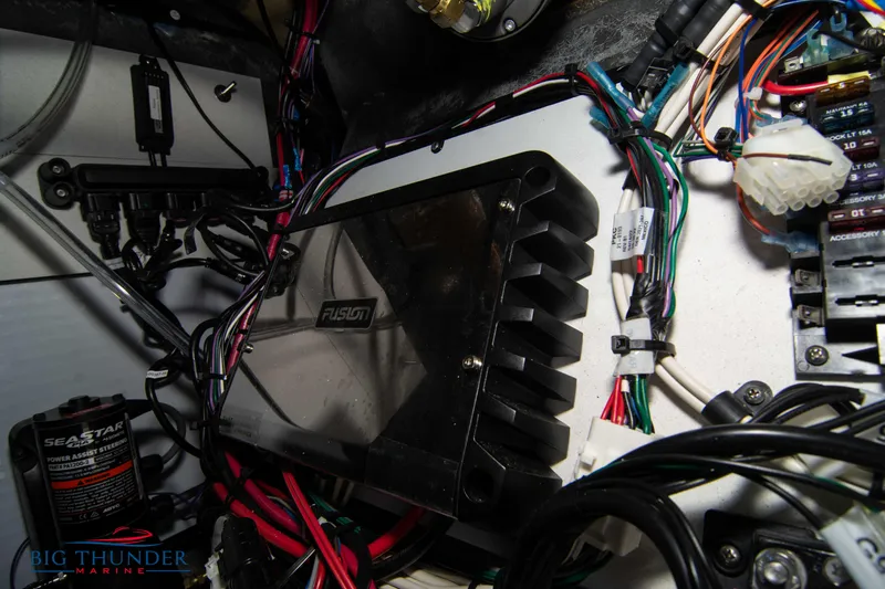 Slide: The Image of 2022 Manitou 23 Encore RF SHP boat wiring and electronics, featuring Fusion audio system. - 38