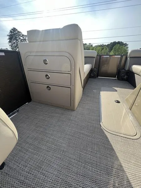 Slide: The Image of 2023 Crest Classic DLX 220 SLRC CPT DLX interior with beige seating and storage compartments. - 12