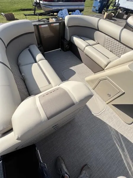 Slide: The Image of 2023 Crest Classic DLX 220 SLRC CPT DLX boat interior with plush seating and modern design. - 2