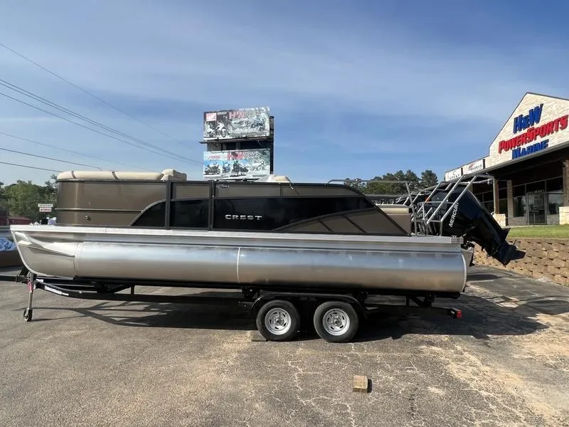 Slide: The Image of 2023 Crest Classic DLX 220 SLRC pontoon boat on trailer at dealership. - 3