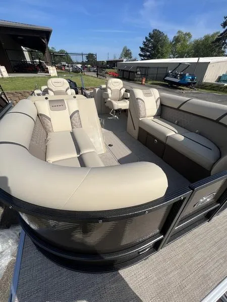 Slide: The Image of 2023 Crest Classic DLX 220 SLRC CPT DLX pontoon boat with beige seating and spacious interior. - 7