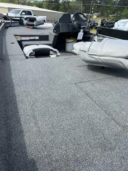 Slide: The Image of 2023 Crestliner 1700 Storm boat interior with gray carpet and seating. - 6