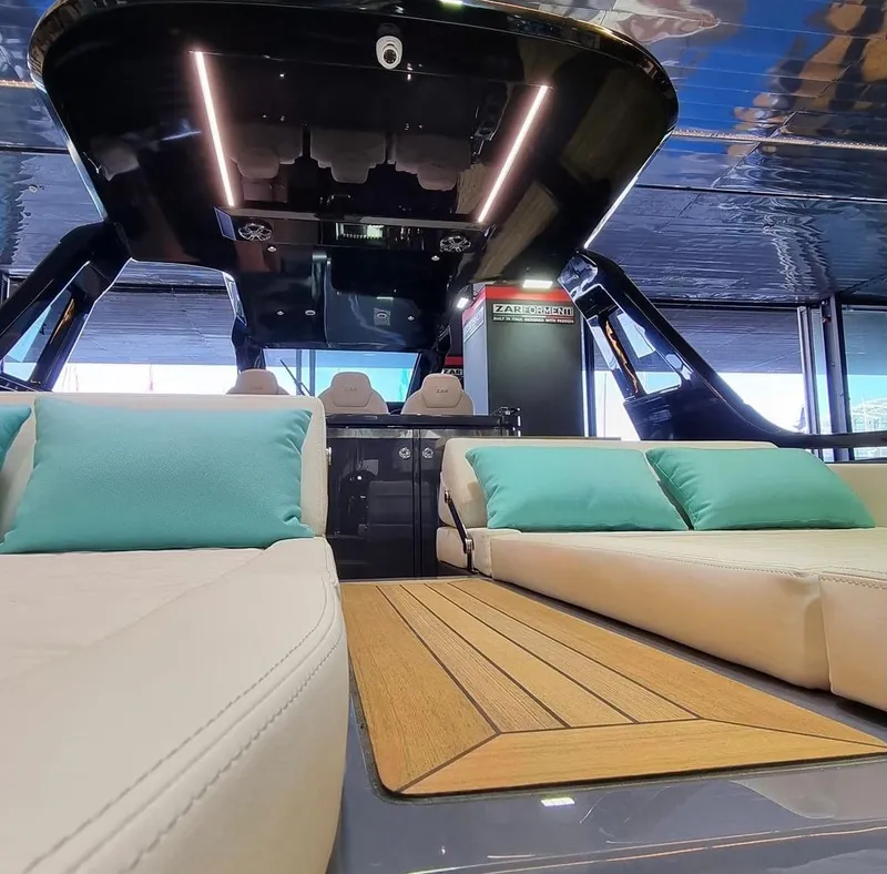 Slide: The Image of Interior of 2024 Zar Formenti Imagine 130 luxury yacht with beige seating and turquoise cushions. - 19