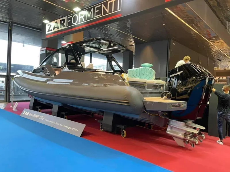 Slide: The Image of 2024 Zar Formenti Imagine 130 boat on display at an indoor exhibition. - 2